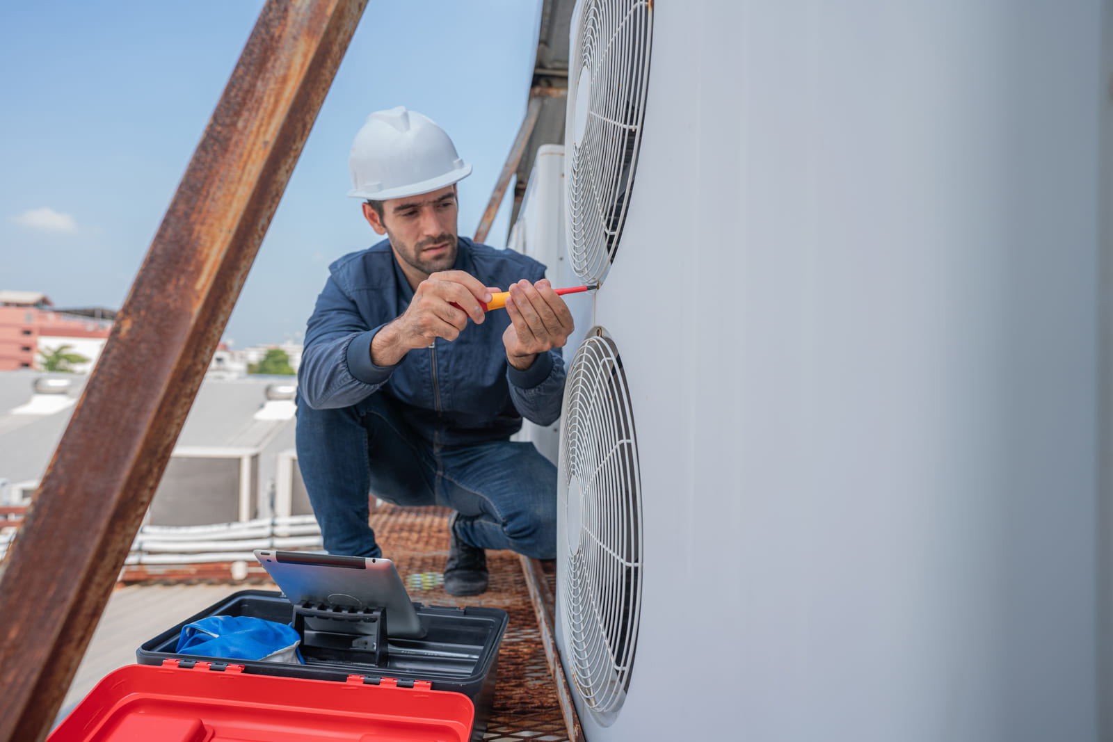 HVAC technician servicing a rooftop air conditioning unit